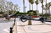  Harbour promenade with dolphin mosaic, rental bicycles, tourist train and town hall in Kos Town on the island of Kos in Greece 