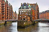 tea house and restaurant Wasserschloss in the warehouse district (Speicherstadt) viewed from the PoggenmuhlenBrucke bridge, HafenCity quarter, Hamburg, Germany, Europe