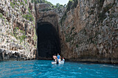 Tourist boat in front of the Haxhi Ali cave, Peninsula of Karaburun, within the Karaburun-Sazan Marine Parc, Vlore bay, Albania, Southeastern Europe