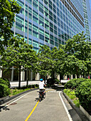 Cyclist on bicycle path alongside Goldman Sachs Global Headquarters, 200 West Street, New York City, New York, USA