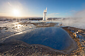  Blesi spring and Strokkur geyser (butter churn geyser) in the Haukadalur hot water valley, winter, Iceland 