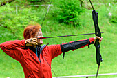  Woman archery, Millstätter See, Nockberge, Niedere Tauern, Carinthia, Austria 