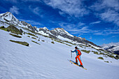  Woman on ski tour ascending to Heilig-Geist-Jöchl, Heilig-Geist-Jöchl, Zillertal Alps, Tyrol, Austria 