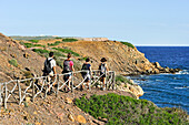 ramblers on the Cami de Cavalls (hiking trail GR 223), near Punta Negra on the  North Coast, Menorca, Balearic Islands, Spain, Europe