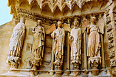  Left jamb of the left west portal with smiling angel at the cathedral with rosette and stained glass windows with depictions of kings in Reims in the wine-growing region of Champagne in the Marne department in the Grande Est region of France 