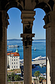 view of the ferry port through bell tower's columns of the Cathedral, Old Town, Split, Croatia, Southeast Europe