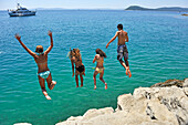 teenagers diving from rocks outside Jezinac beach at the foot of Marjane hill, Split, Croatia, Southeast Europe