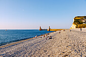  Beach and view of the harbor entrance at sunset in Fécamp (Fecamp) on the Alabaster Coast (Côte d&#39;Albâtre, Cote d&#39;Albatre) in the Seine-Maritime department in the Normandy region of France 