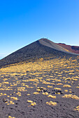 Group of hikers walking around crater rim, Etna, Sicily, Italy