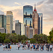 People walk in the Huacheng Square surrounded by modern high-rise buildings. Zhujiang New Town, Tianhe District, Guangzhou, Guangdong Province, China.