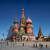 People walk in front of the 16th century Cathedral of Vasily the Blessed, aka Saint Basil's Cathedral. Red Square, Moscow, Russian Federation.