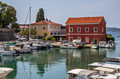  Zadarske gradske zidine, historic harbor with small boats and a distinctive red house. Zadar, Adriatic, Dalmatia, Croatia, Mediterranean 