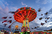  Swing carousel at Oktoberfest 2024 at dusk, Munich, Bavaria, Germany  