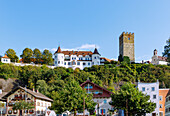  Historic market square with Haus zum Sailer (guest information) with Lüftlmalerei and view of Neubeuern Castle in Neubeuern in Chiemgau in Upper Bavaria in Germany 