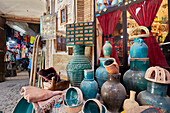 A selection of handmade pottery displayed at shopfront in the Aminoddole Caravanserai, historic structure in the Grand Bazaar of Kashan, Iran.