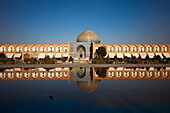 Frontal view of the Lotfollah Mosque reflected in a water pool. Naqsh-e Jahan Square, Isfahan, Iran.