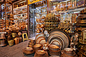 Handmade copper utensils and decorative items displayed at a handicraft shop in Isfahan, Iran.