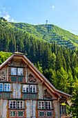 Beautiful Old Town with a House and Mountain in a Sunny Summer Day in Andermatt, Uri, Switzerland.