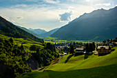 Beautiful Panoramic View over Old Cityscape and Golf Course with Mountainscape and Mountain Valley in a Sunny Summer Day in Andermatt, Uri, Switzerland.