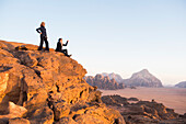 Two women enjoying sunset in Wadi Rum desert, UNESCO World Heritage site, Jordan, Near East, Southern Levant, West Asia