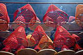 Burning incense spirals hang from ceiling in the Tin Hau Temple Complex. Yau Ma Tei, Kowloon, Hong Kong, China.