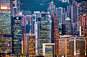 Close up view of the modern high-rise buildings at Central Waterfront illuminated at night. Hong Kong, China.