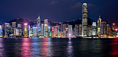 Panoramic view a of high-rise waterfront buildings illuminated at night. Hong Kong, China.