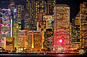 Close up view of the modern high-rise buildings at Central Waterfront illuminated at night. Hong Kong, China.