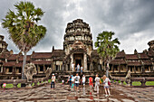 Tourists walk in the Angkor Wat temple. Angkor Archaeological Park, Siem Reap Province, Cambodia.