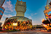 Colourful building of the Hotel Grand Lisboa illuminated at dusk. Macau, China.