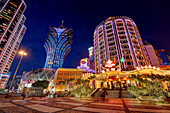 Hotels Lisboa and Grand Lisboa illuminated at night. Macau, China.