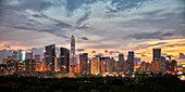 Panoramic view of the high-rise buildings in Futian District illuminated at dusk. Shenzhen, Guangdong Province, China.