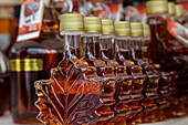  Maple syrup in bottles shaped like maple leaves for sale at farmers market, Kingston, Ontario, Canada, North America 