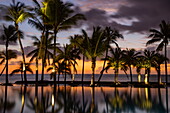 Reflection of coconut palm trees in swimming pool at Trou aux Biches Beachcomber Golf Resort & Spa (Beachcomber Resorts) at sunset, Trou aux Biches, Pamplemousses, Mauritius, Indian Ocean