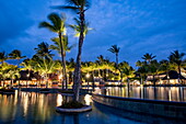 Swimming pool, restaurant and coconut palm trees at Trou aux Biches Beachcomber Golf Resort & Spa (Beachcomber Resorts) at dusk, Trou aux Biches, Pamplemousses, Mauritius, Indian Ocean