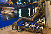 Siren’s bench on the embankment of the Dane River, old harbour of Klaipeda, port city on the Baltic Sea, Lithuania, Europe