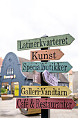  Colorful wooden signs in the pedestrian zone of Nyköbing, Falster, Denmark, Europe 