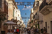  The lyrics of the song VOLARE Nel blu dipinto di blu as lighting over the pedestrian zone Via Roma, Polignano a Mare, Apulia, Italy, Europe 