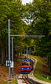 Mountain Train on Railroad Tracks in the Autumn Forest in Monte Generoso, Ticino, Switzerland.