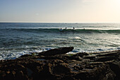  Surfers in the waves of Taghazout near the surf spot &quot;Anker Point&quot;. 