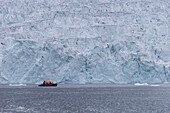  Inflatable boat with tourists at the Samarinbreen glacier, Hornsund, Spitsbergen, Norway 