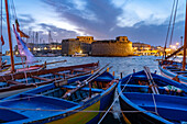  Typical fishing boats and the Castello di Gallipoli fortress at dusk, Gallipoli, Apulia, Italy, Europe 