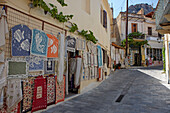 A selection of handmade rugs displayed at the entrance to a gift shop in Kritsa village, Crete, Greece.