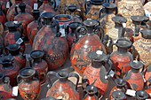 A selection of replicas of ancient Greek amphorae displayed at an outdoor pottery market. Crete, Greece.