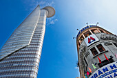 A view from below of the modern Bitexco Financial Tower and a nearby building. Ho Chi Minh City, Vietnam.