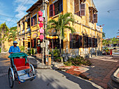 Cyclo drives in Hoi An Ancient Town. Quang Nam Province, Vietnam.