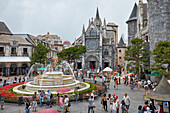 People walk at the water fountain in Fantasy Amusement Park. Ba Na Hills Mountain Resort near Da Nang, Vietnam.