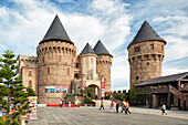 People walk in the Fantasy Amusement Park. Ba Na Hills Mountain Resort, Da Nang, Vietnam.