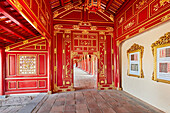 Open gallery in Can Thanh Palace (Emperor's Private Palace) with vivid red painting. Imperial City, Hue, Vietnam.