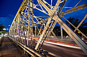 Truong Tien Bridge (designed by Gustave Eiffel) across Perfume River illuminated at dusk. Hue, Vietnam.